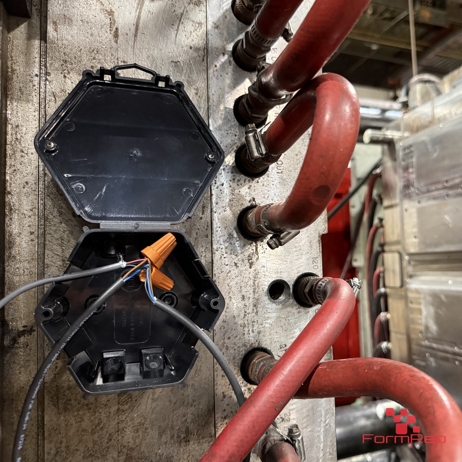 Open Splice Junction Box open on an injection mold Open Splice Junction Box open on an injection mold, showing a wire splice inside