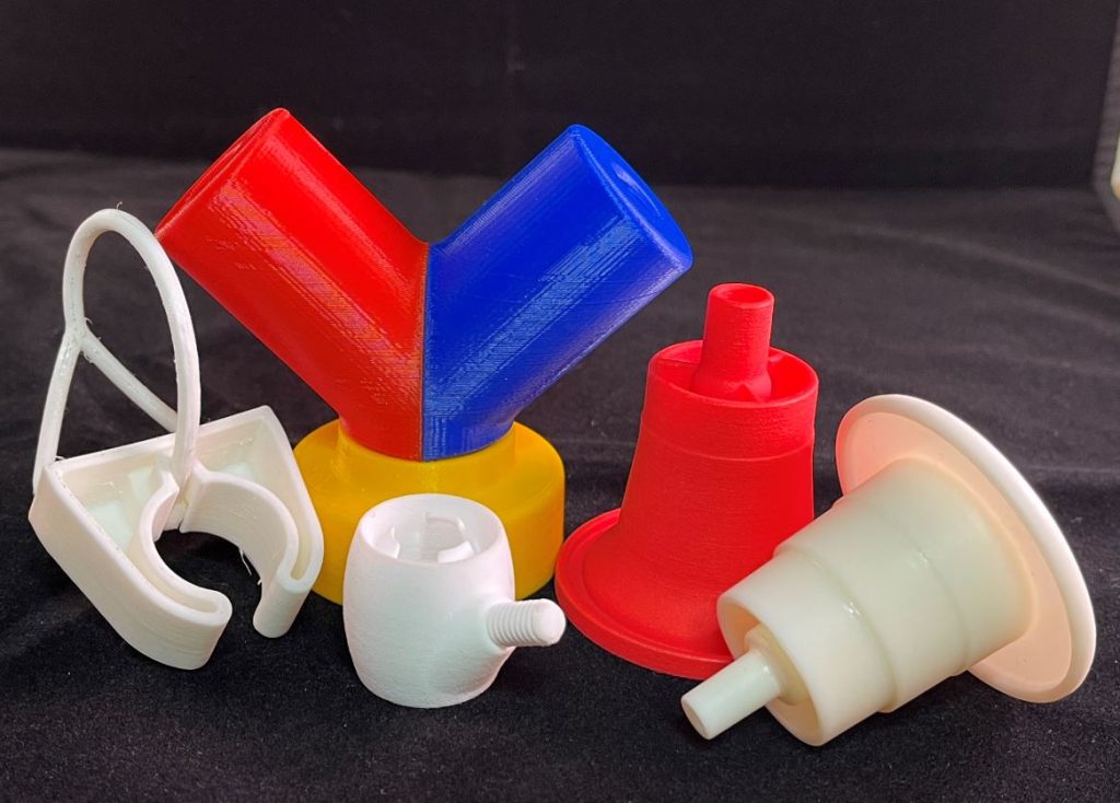 3D printed dispensing adapters in assorted colors