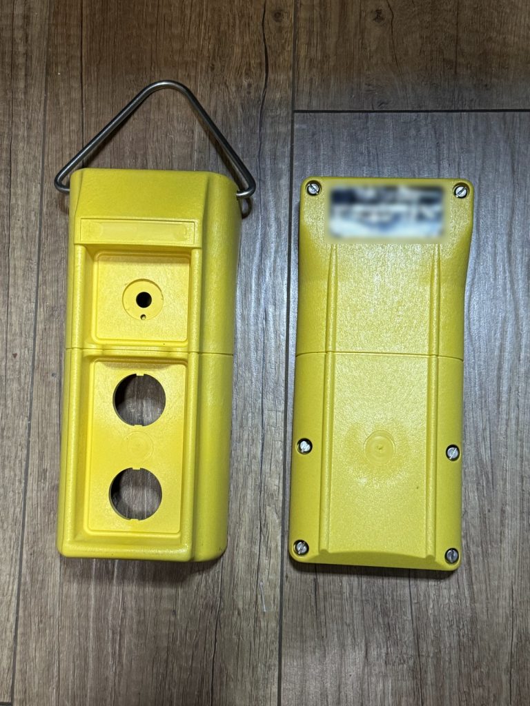 Original pendant enclosure with a printed adhesive label on the back (identifying text blurred)