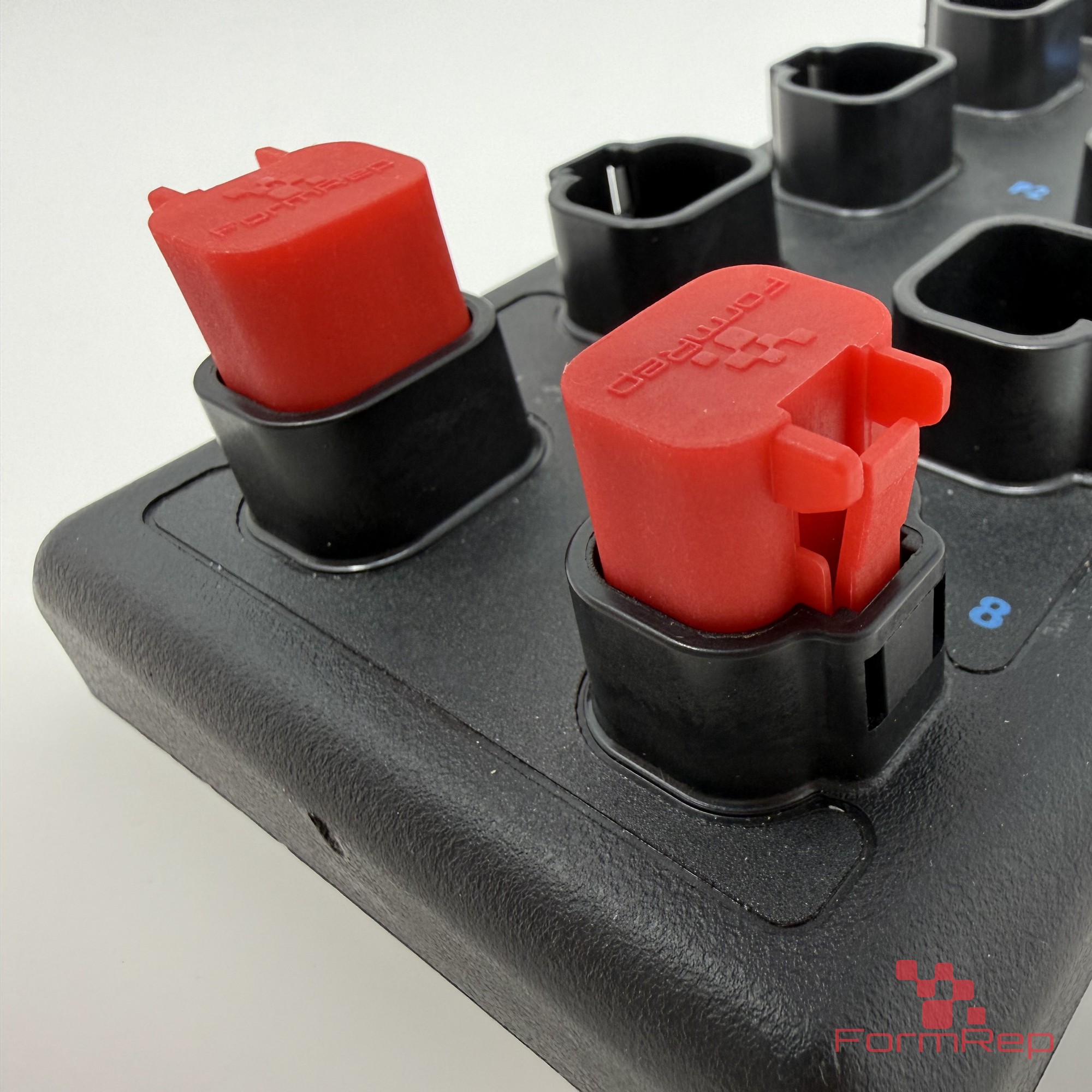 Socket Lock 4-Pin DT-Style Sealing Plug installed on an I/O module Two red Socket Lock 4-pin DT-style sealing plugs installed in unused ports on an I/O module