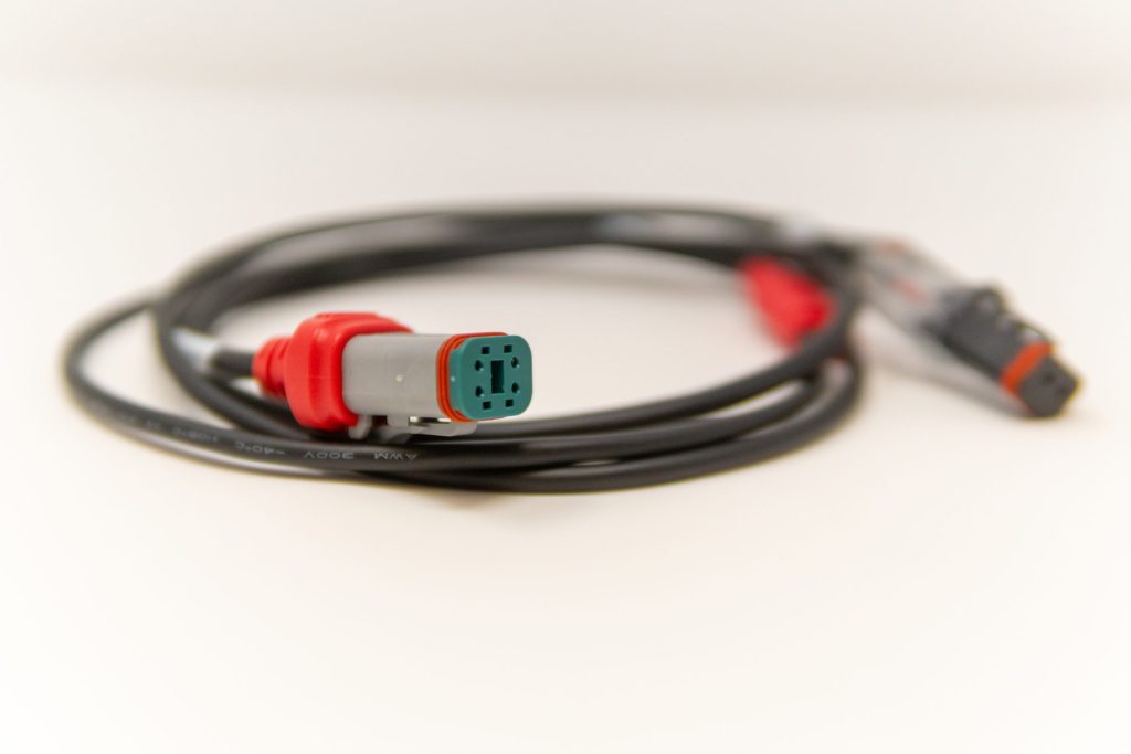 DT cable assembly with red overmolded boots on both ends