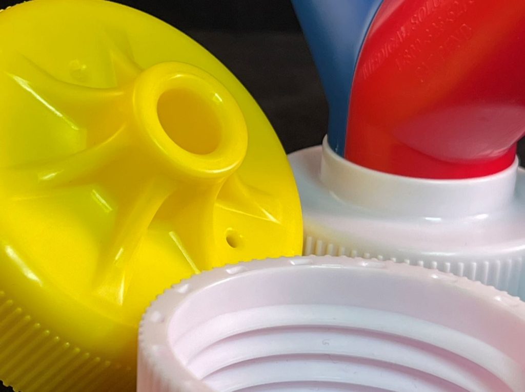 Close-up of molded bottle cap and dispensing adapters