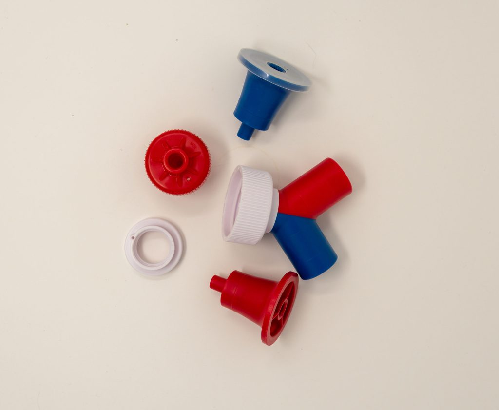Assorted molded caps, plugs, and dispensing parts
