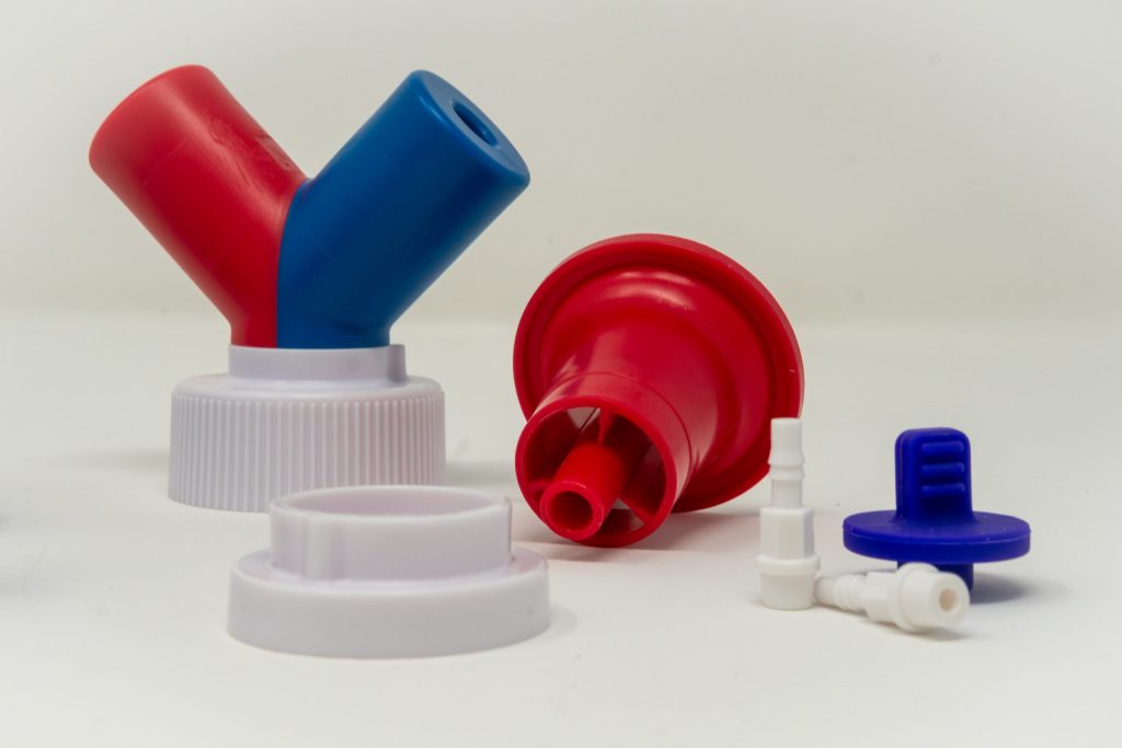 Molded bottle caps, spouts, and dispensing adapters